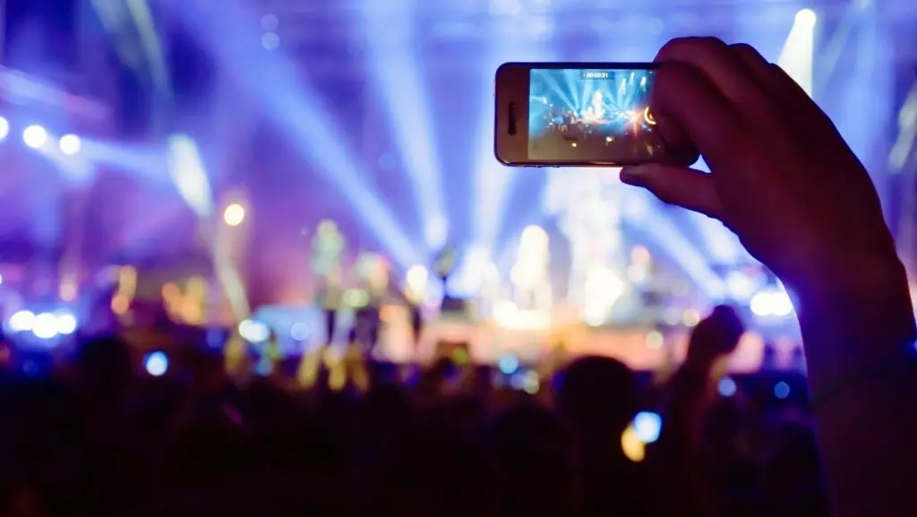 Fan taking photo of concert