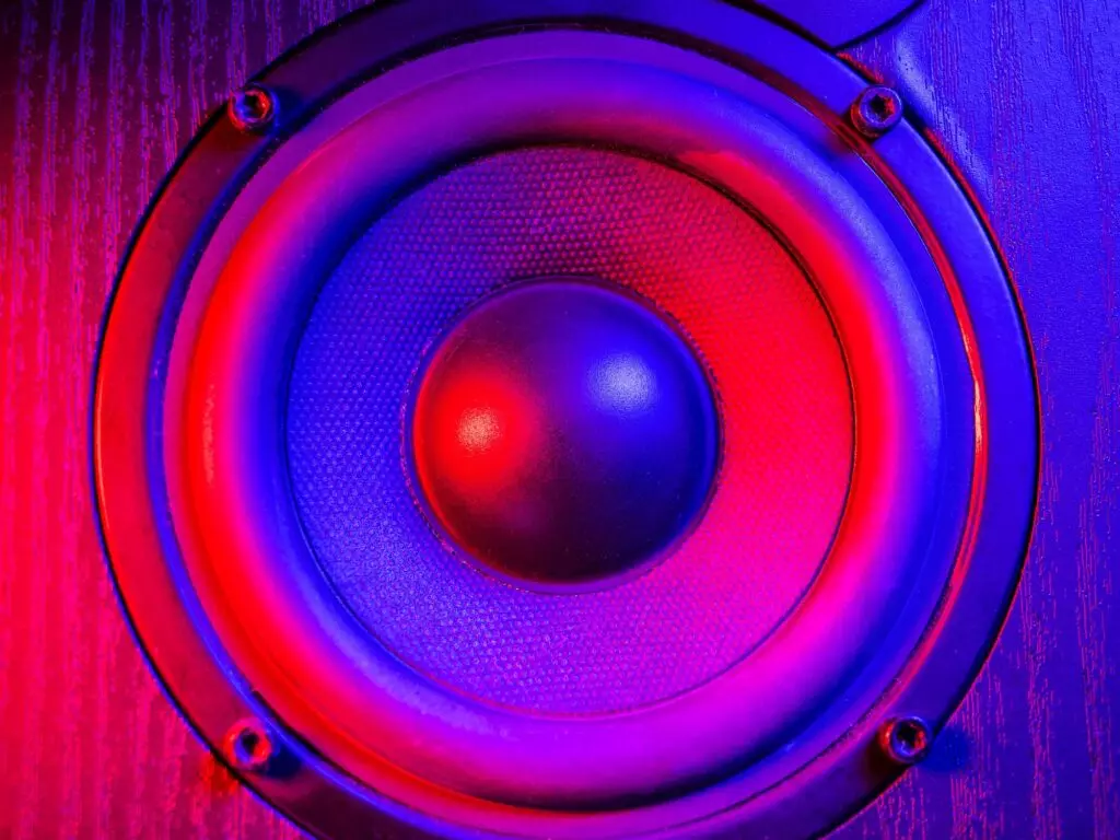 Loudspeaker close up under colorful neon light. Music concept