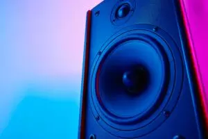 Stereo sound speaker on neon colored background